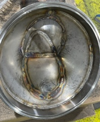 A piece of metal work before polishing, with dim/dark surfaces