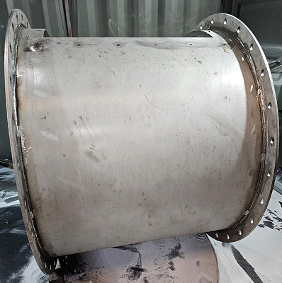 A piece of metal work before polishing, with dim/dark surfaces