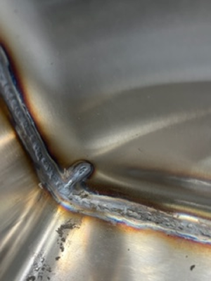 A piece of metal work before polishing, with dim/dark surfaces